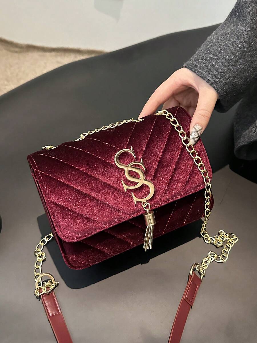 Refined Embossed Letter Shoulder Bag – New Year Collection in deep burgundy with chain strap and embossed detailing.