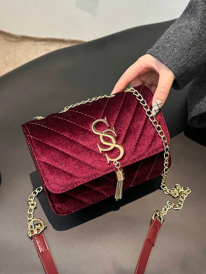 Refined Embossed Letter Shoulder Bag – New Year Collection in deep burgundy with chain strap and embossed detailing.