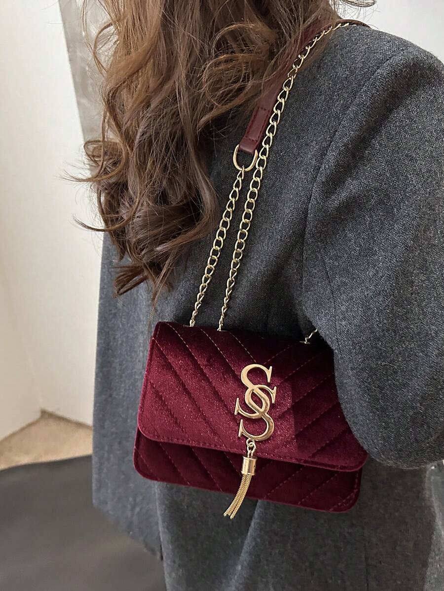 Refined Embossed Letter Shoulder Bag – New Year Collection worn as a stylish crossbody bag.
