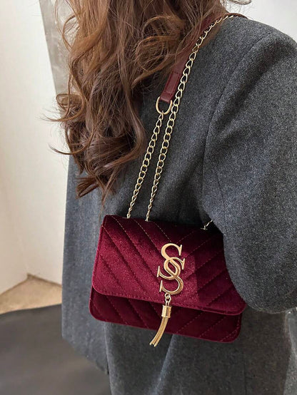 Refined Embossed Letter Shoulder Bag – New Year Collection worn as a stylish crossbody bag.