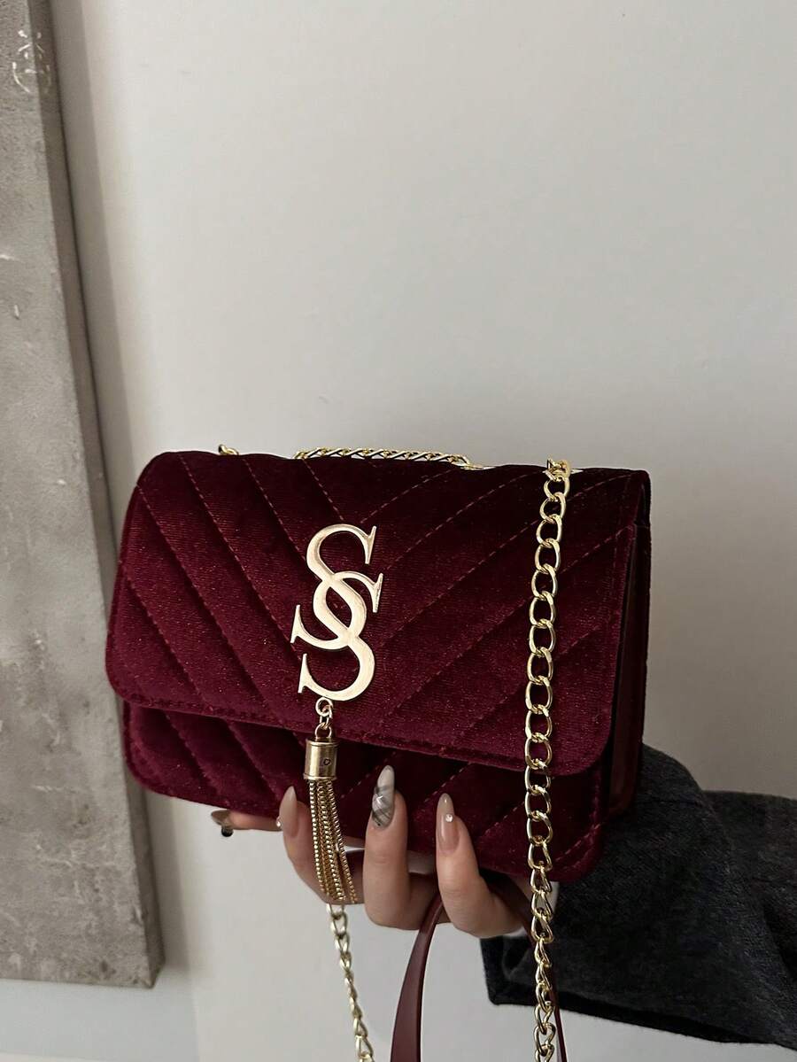 Refined Embossed Letter Shoulder Bag – New Year Collection in burgundy with gold chain.