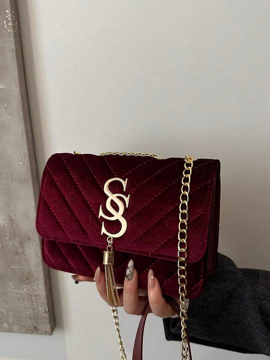 Refined Embossed Letter Shoulder Bag – New Year Collection in burgundy with gold chain.