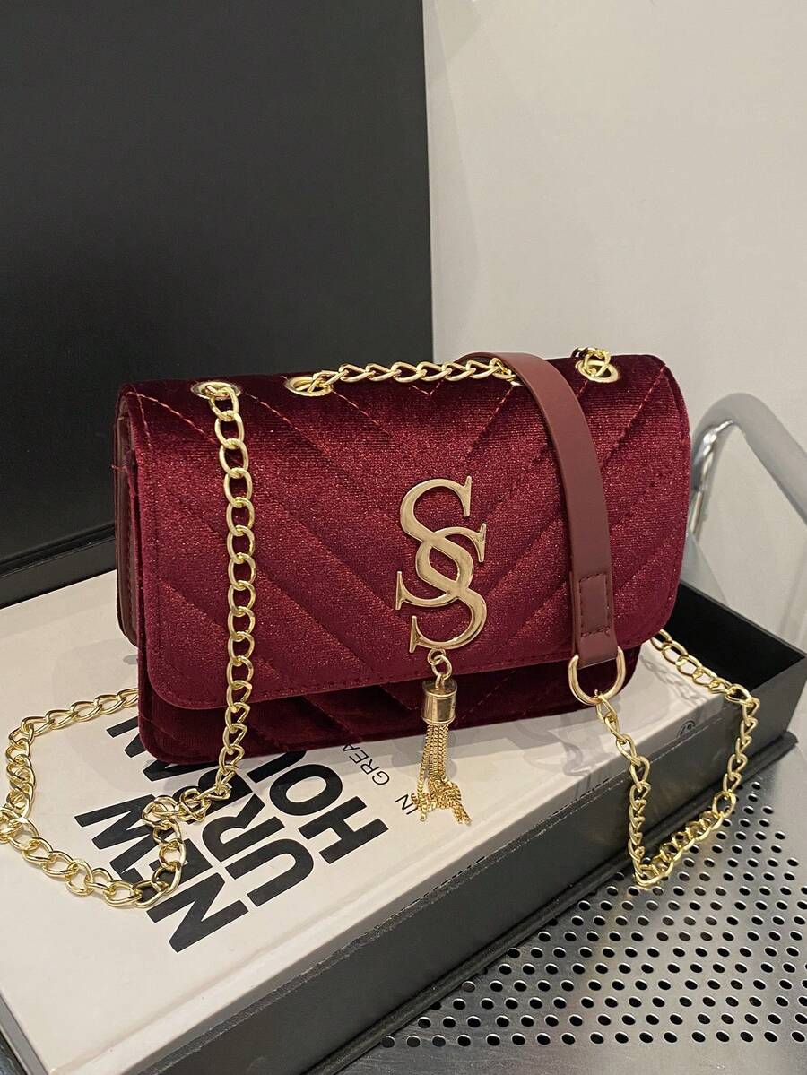 Refined Embossed Letter Shoulder Bag – New Year Collection in burgundy velvet with gold chain.