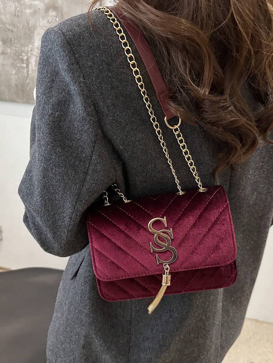 Refined Embossed Letter Shoulder Bag – New Year Collection in burgundy, worn on the shoulder with stylish chain.