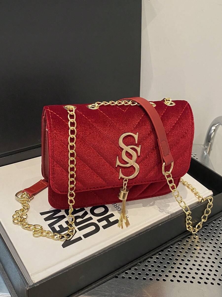 Refined Embossed Letter Shoulder Bag – New Year Collection in red velvet with gold accents and chain strap.