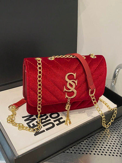 Refined Embossed Letter Shoulder Bag – New Year Collection in red velvet with gold accents and chain strap.