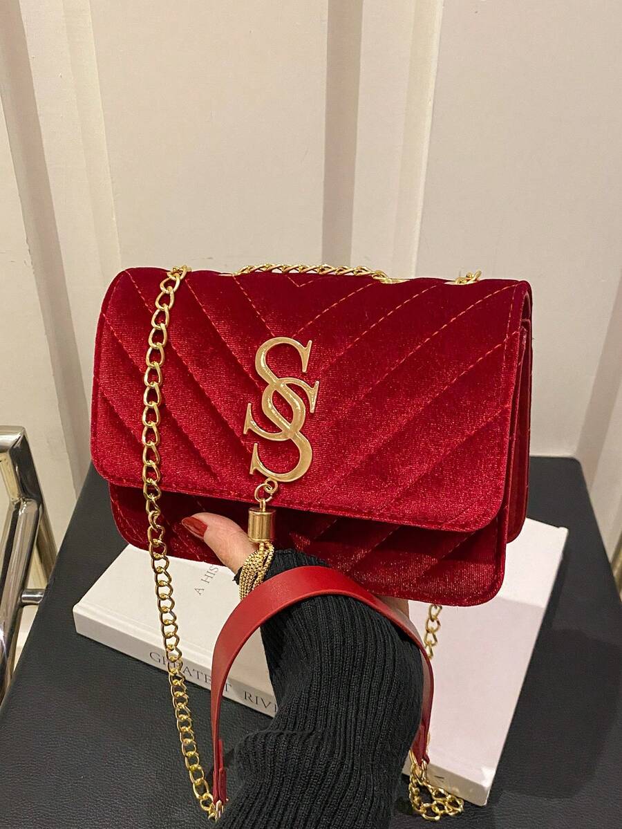 Refined Embossed Letter Shoulder Bag – New Year Collection displayed in red with gold chain.