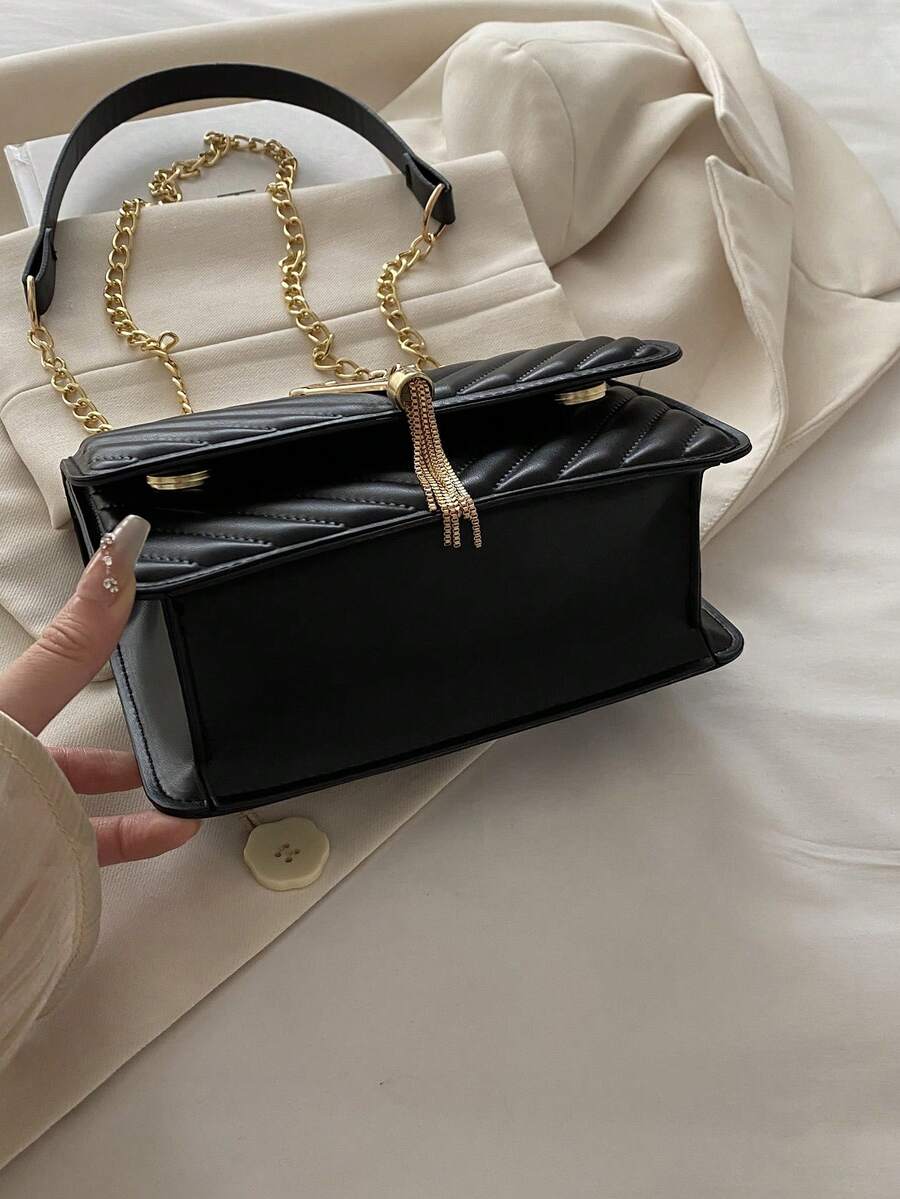 Refined Embossed Letter Shoulder Bag – New Year Collection displayed elegantly with chain strap on a stylish background.