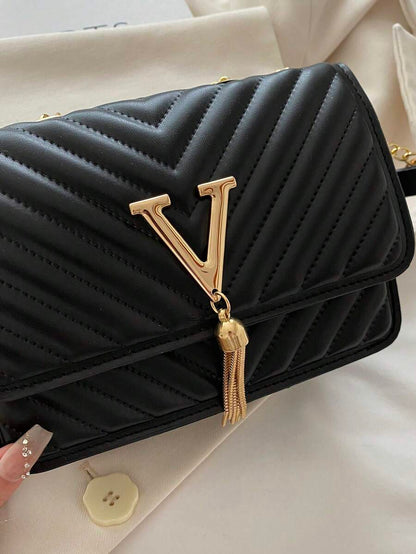 Refined Embossed Letter Shoulder Bag – New Year Collection in black with gold detailing and tassel