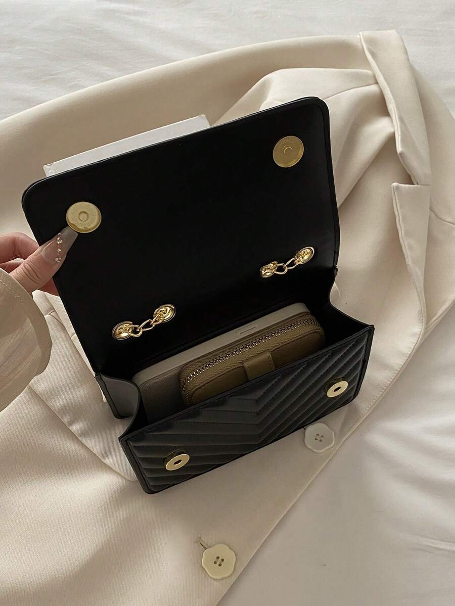 Refined Embossed Letter Shoulder Bag – New Year Collection with open flap showcasing interior wallet and buttons.
