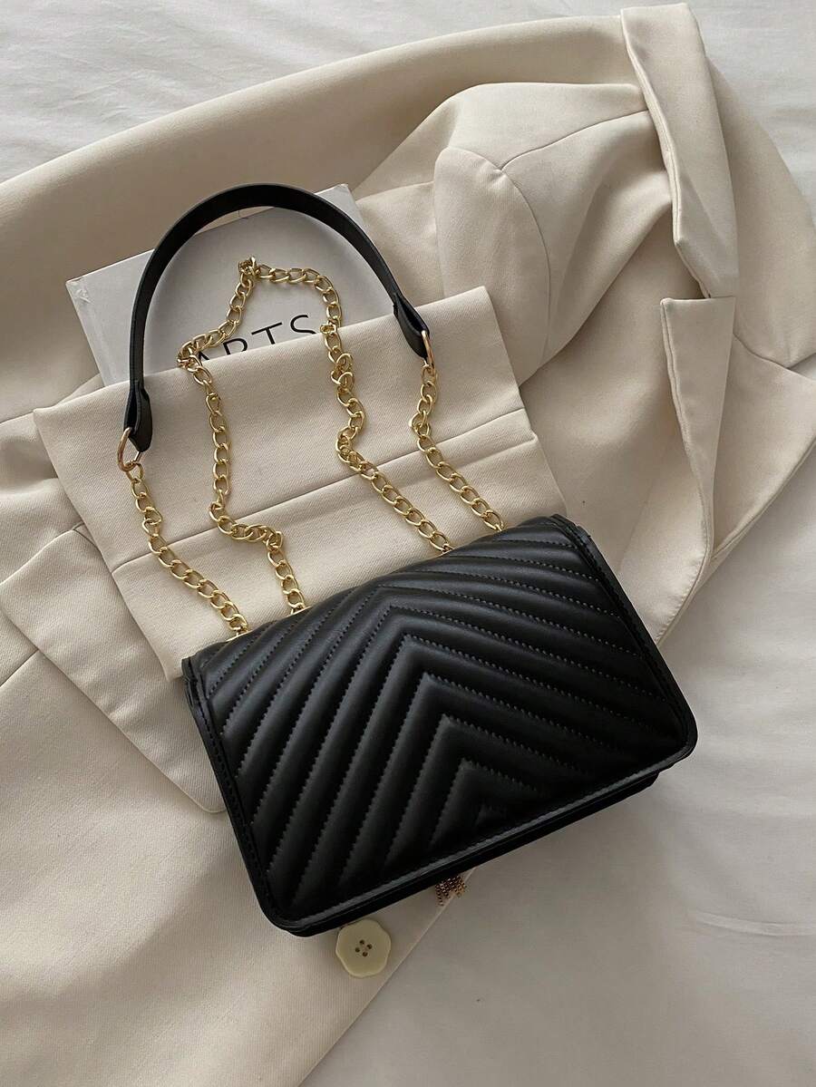 Refined Embossed Letter Shoulder Bag – New Year Collection styled with a chic outfit and gold chain detailing.