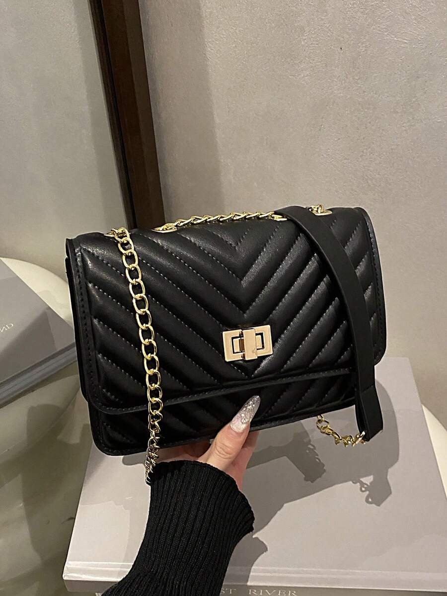 Refined Embossed Letter Shoulder Bag – New Year Collection in black, featuring a chevron design and chain strap.