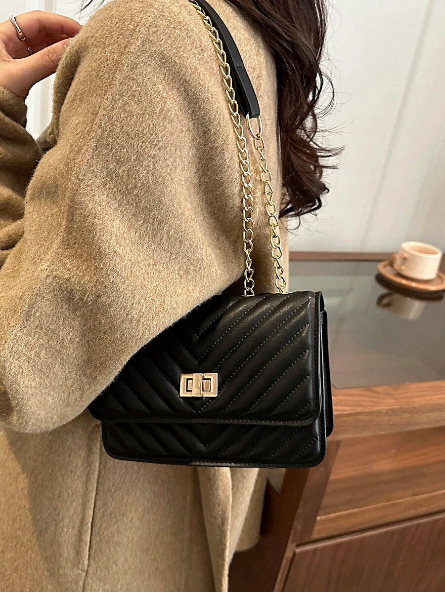 Refined Embossed Letter Shoulder Bag – New Year Collection displayed elegantly on a model's shoulder.