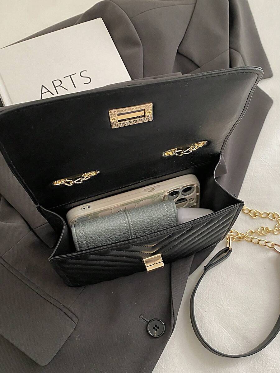 Refined Embossed Letter Shoulder Bag – New Year Collection open, showcasing phone and wallet inside, stylish black handbag.