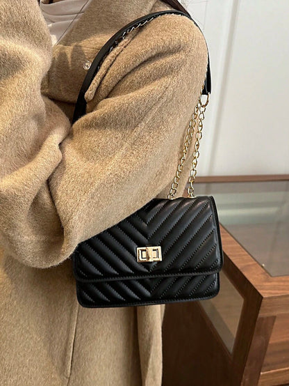 Refined Embossed Letter Shoulder Bag – New Year Collection in black with chain strap, stylish and versatile for modern women.