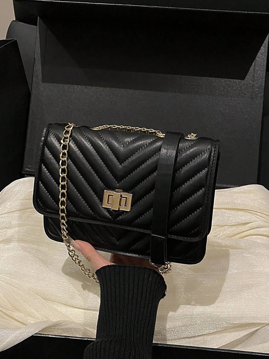 Refined Embossed Letter Shoulder Bag – New Year Collection showcased in a stylish black design with quilted pattern.