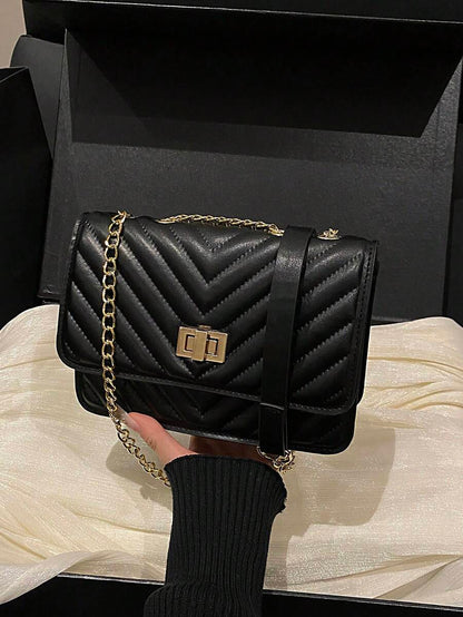 Refined Embossed Letter Shoulder Bag – New Year Collection showcased in a stylish black design with quilted pattern.