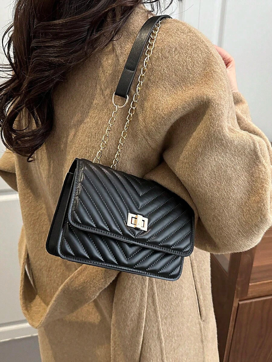 Refined Embossed Letter Shoulder Bag – New Year Collection on a woman's shoulder, showcasing elegant design and versatility.
