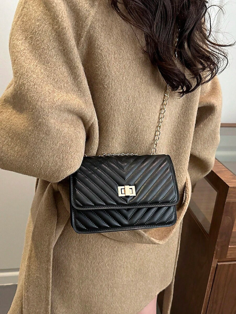 Refined Embossed Letter Shoulder Bag – New Year Collection worn on shoulder with elegant styling.