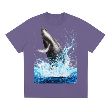Purple t-shirt with a whale graphic on a white background