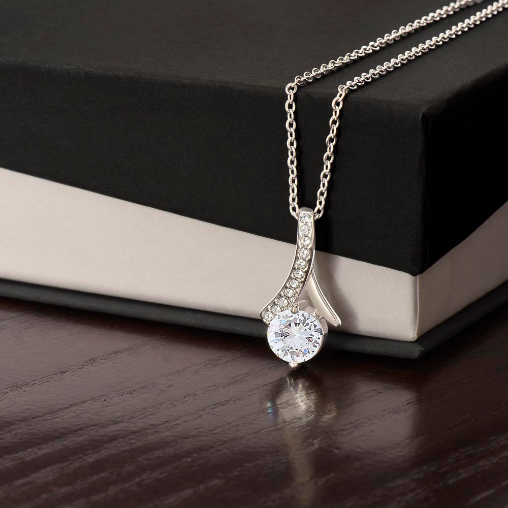 Forever Curve Love Necklace with sparkling cubic zirconia pendant displayed next to a gift box.