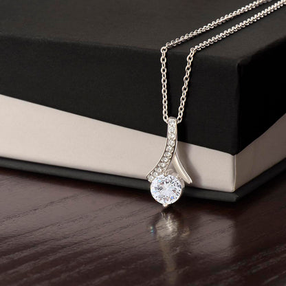 Forever Curve Love Necklace with sparkling cubic zirconia pendant displayed next to a gift box.