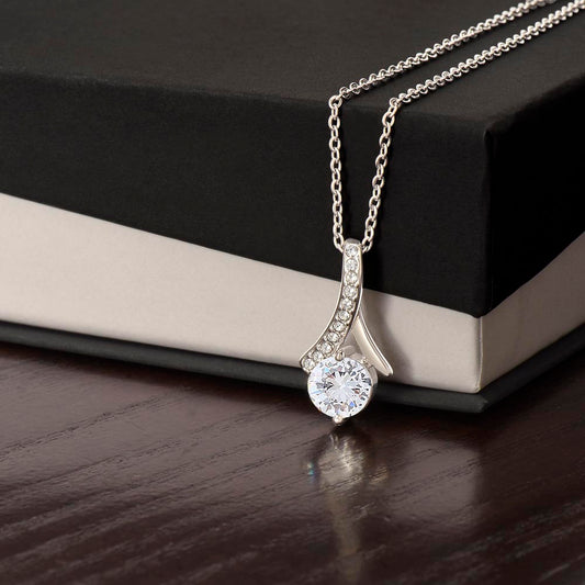 Forever Curve Love Necklace with sparkling cubic zirconia pendant displayed next to a gift box.
