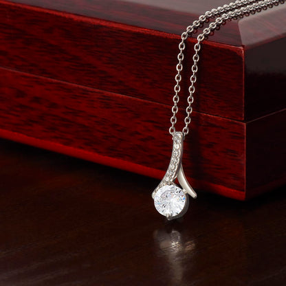 Forever Curve Love Necklace displayed on a wooden box, featuring a sparkling cubic zirconia pendant.