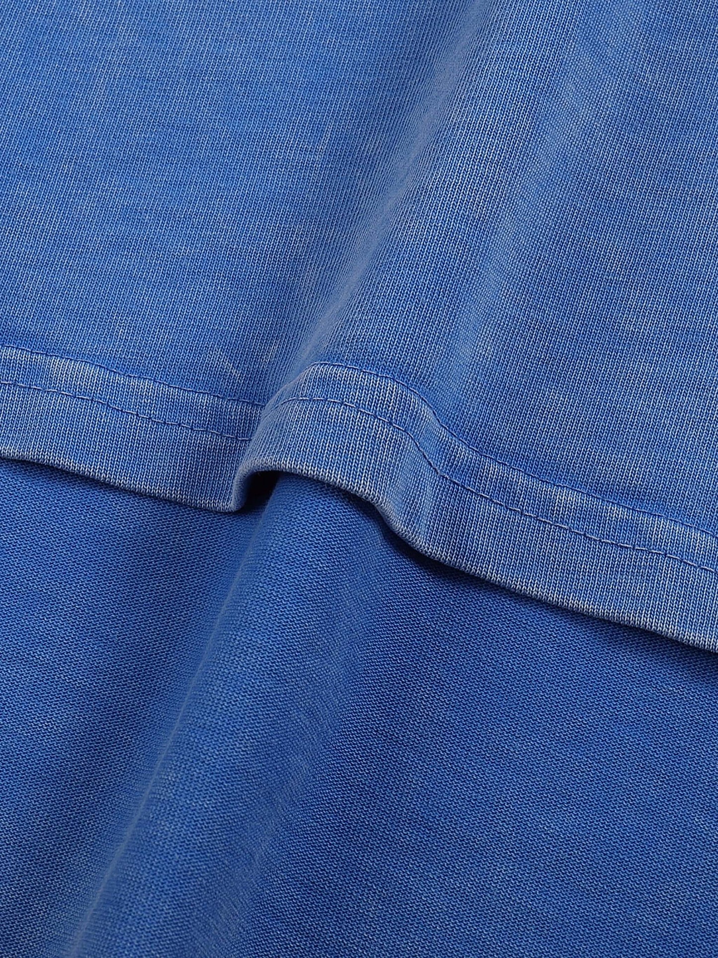 Urbanova-Washed cotton T-Shirt detail showing the snow-wash finish and soft cotton fabric for a relaxed fit.