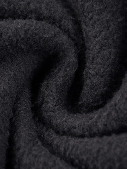 Close-up of soft black fabric showcasing the texture of the URBANOVA-Acid Washed Fleece Hoodie.