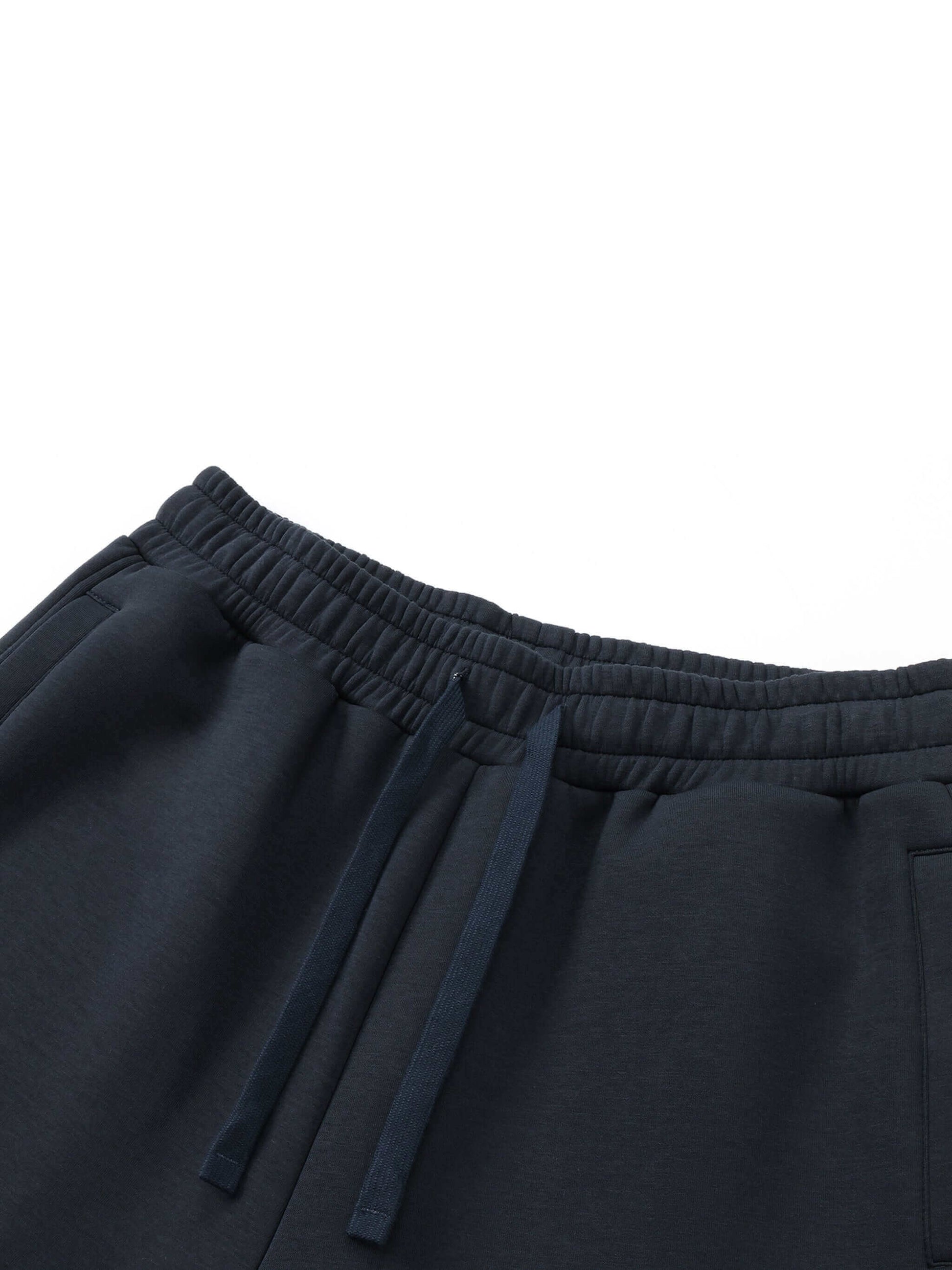 Urbanova Noir Essential Joggers close-up of waistband and drawstrings in dark fabric.