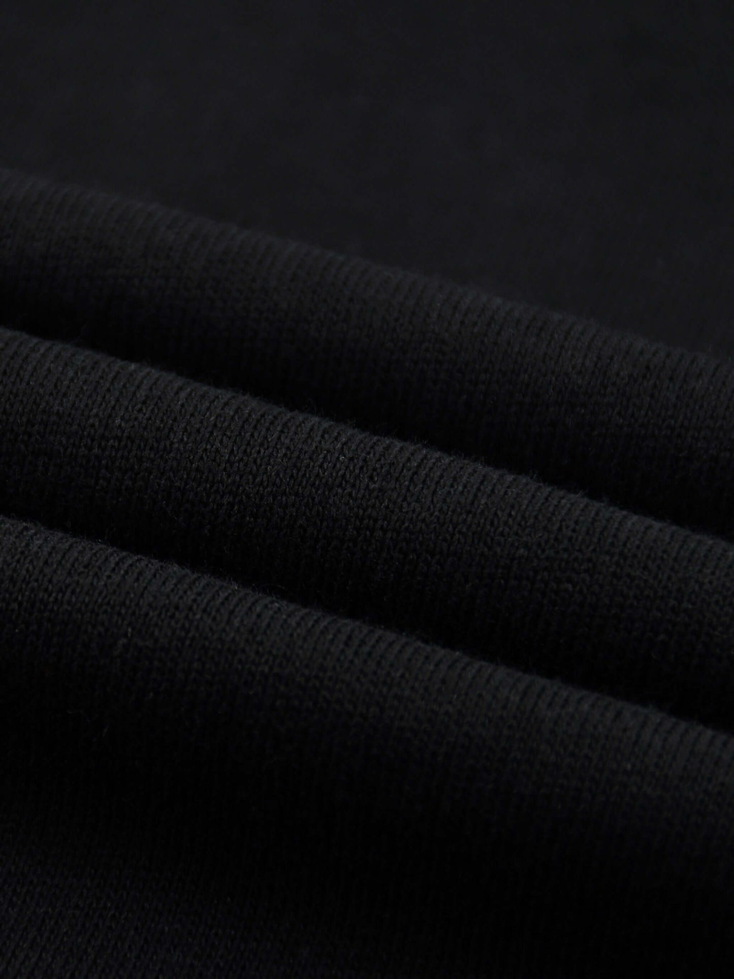 Lightweight Cotton Classic Fit T-Shirt fabric close-up showing soft, thin black cotton texture.